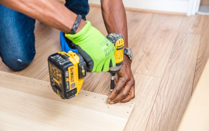 Tightening a screw during furniture assembly, the same fix used on a loose table leg or pedestal joint