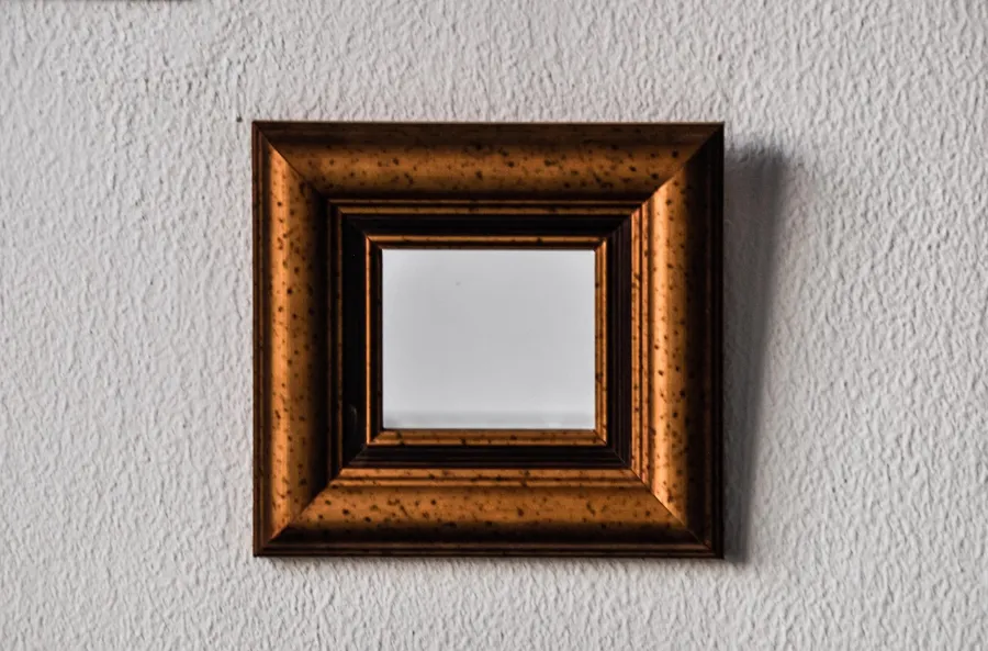 Framed wall mirror in good condition, the kind of care that prevents backing scratches