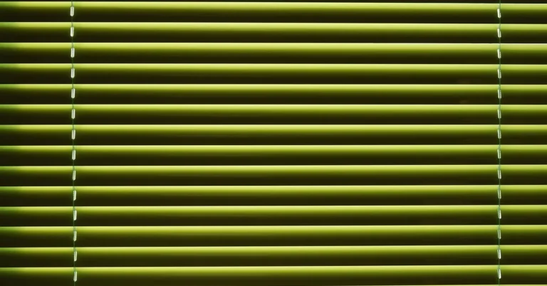 close-up of venetian blind slats letting in horizontal bands of daylight