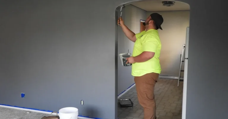 Painter using a roller to estimate and apply wall paint