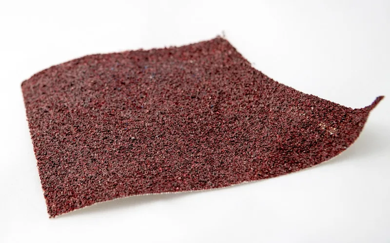 fine-grit sandpaper used to rough up a glossy porcelain surface before priming