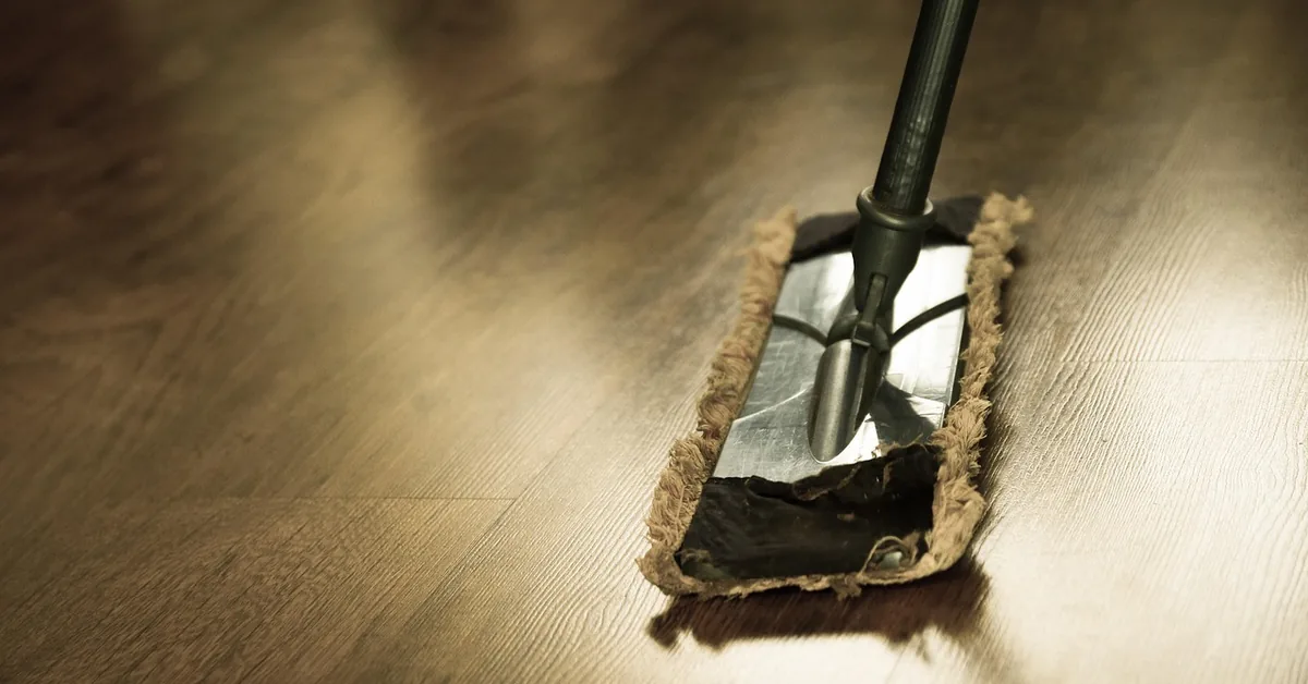 flat mop cleaning a freshly cleaned hardwood floor to a glossy shine