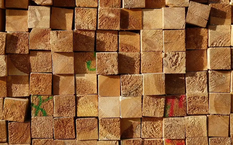 cut ends of stacked lumber showing colored grading marks used to sort board quality