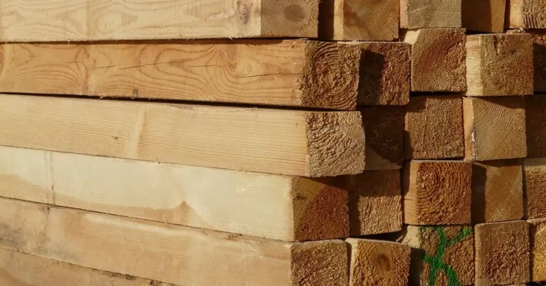 close-up of stacked dimensional lumber boards with cut ends showing grain and grading marks