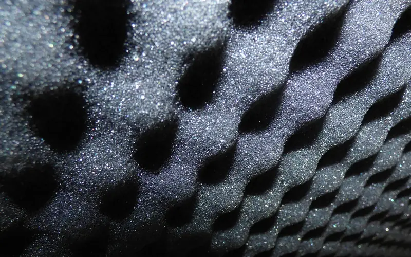 Wedge-cut acoustic foam panel texture used for echo control in a music room Wedge-cut acoustic foam panel texture used for echo control in a music room