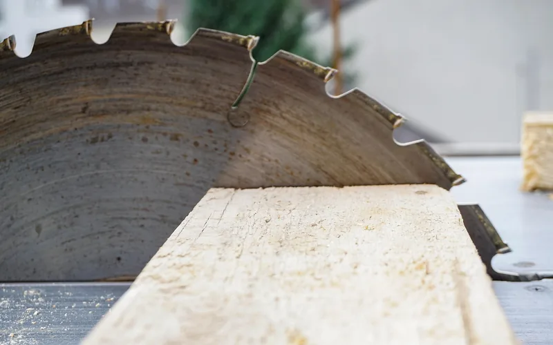 Circular saw blade cutting through wood, close-up
