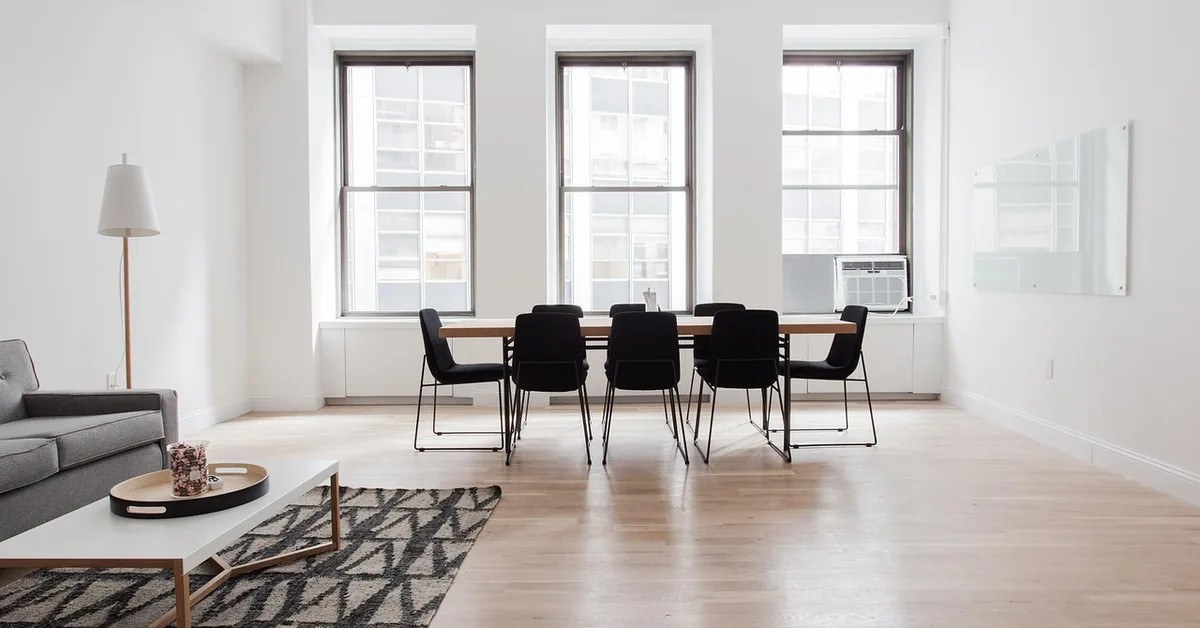 Area rug anchored under a coffee table on a light hardwood floor in a modern living room