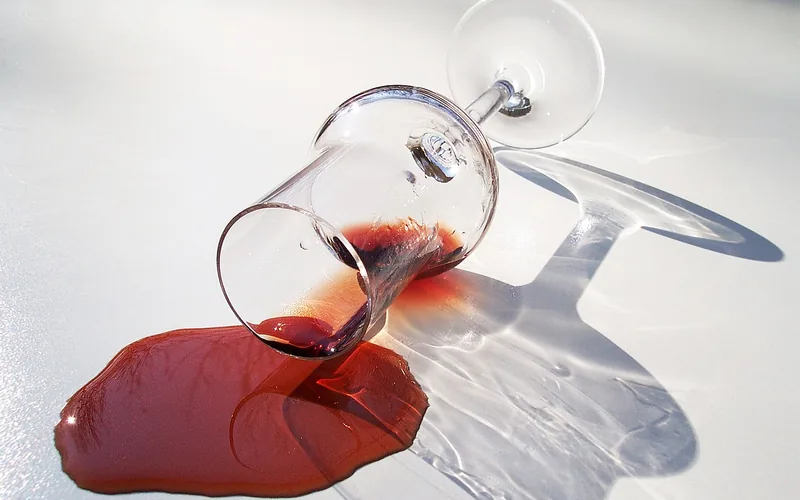 red wine spilled from a glass, the kind of stain that soaks into laminate if not blotted quickly red wine spilled from a glass, the kind of stain that soaks into laminate if not blotted quickly