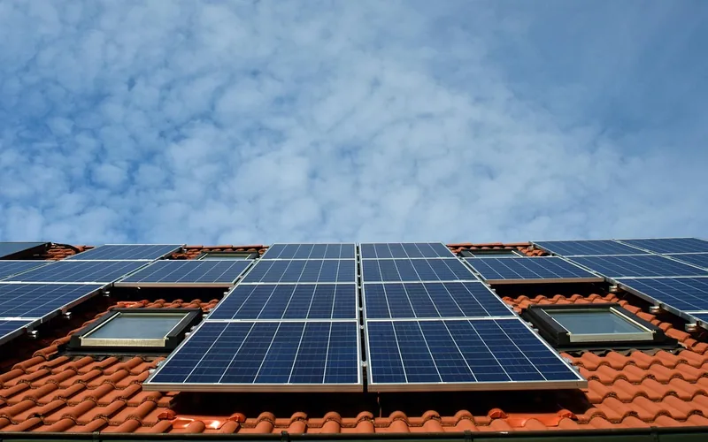 Solar panels installed on a home roof as a renewable heating alternative to wood combustion