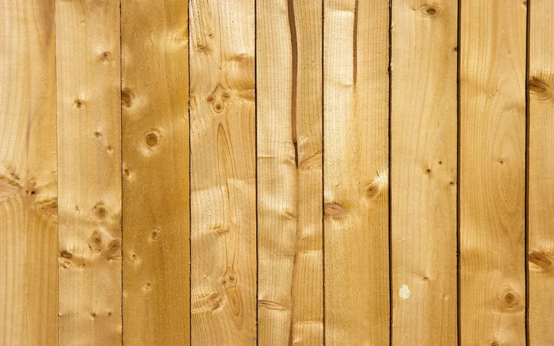 stacked wood plank boards showing grain and knots typical of budget lumber stacked wood plank boards showing grain and knots typical of budget lumber