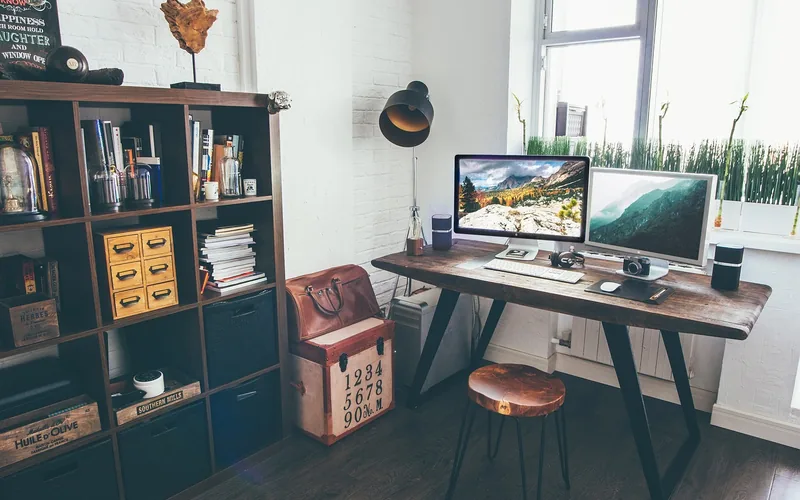 bright study nook with wood desk, bookshelf, and a large window for natural light