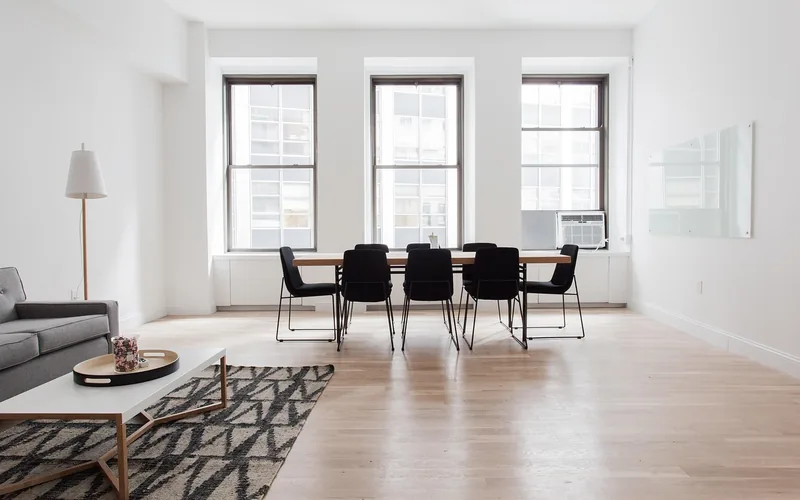 Charcoal-toned furniture and rug in a neutral-toned room