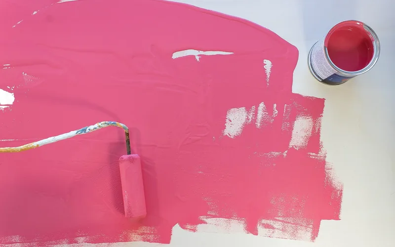 coral-colored paint sample being poured to show an aqua and coral pairing