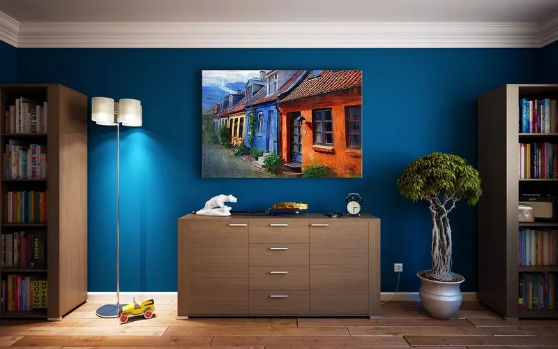 Living room with deep blue walls and a crisp white ceiling and crown molding