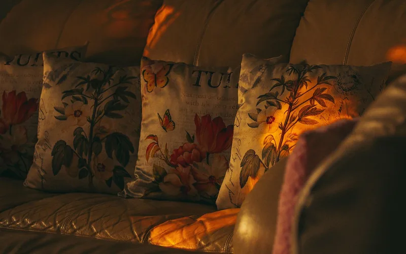 Navy blue accent pillows on a taupe sofa in a living room
