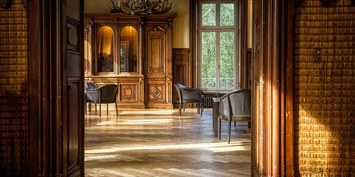finished hardwood parquet floor with a glossy oil-based polyurethane sheen in sunlight