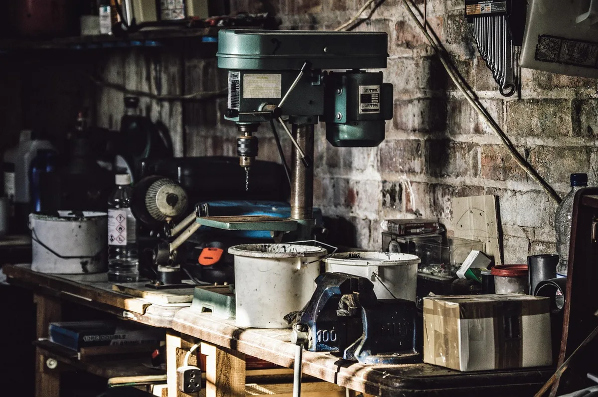 Cordless drill and power tools in a home garage workshop Cordless drill and power tools in a home garage workshop