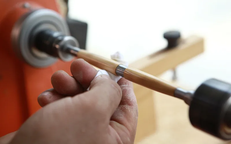 Hand sanding a piece of wood by hand to smooth the surface Hand sanding a piece of wood by hand to smooth the surface
