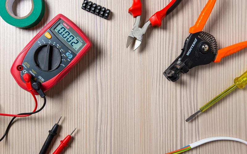 Testing and connecting wires for a ceiling light fixture Voltage tester, wire connectors, and wire strippers used to safely check and join wires on a new LED ceiling light