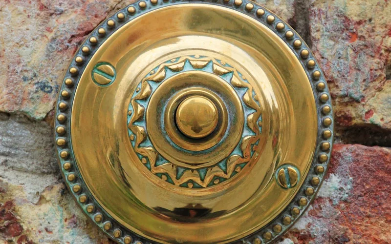 brass hardware with green patina tarnish buildup on an exterior surface