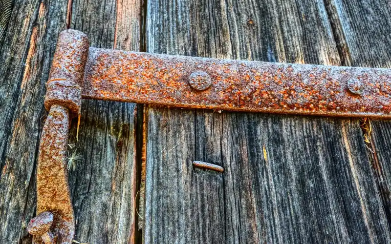 Close-up of a cleaned metal door hinge after paint removal Close-up of a cleaned metal door hinge after paint removal