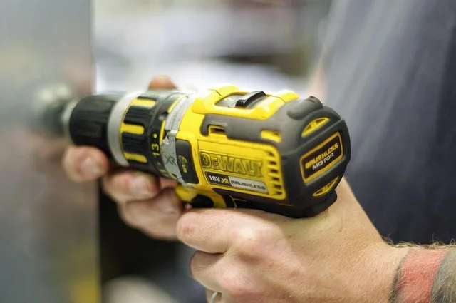 Cordless drill used to secure cabinet door hinge screws