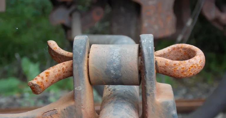 Rusty cotter pin fastener locking a clevis joint on rail machinery