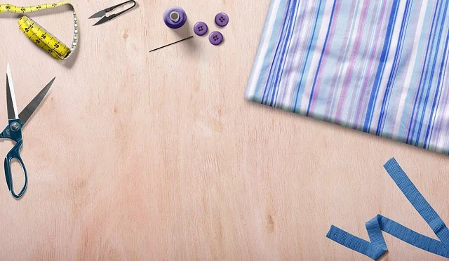 Fabric, scissors, and measuring tools for marking snap placement