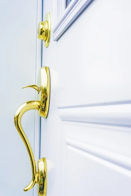Modern gold door knob replacing an outdated fixture