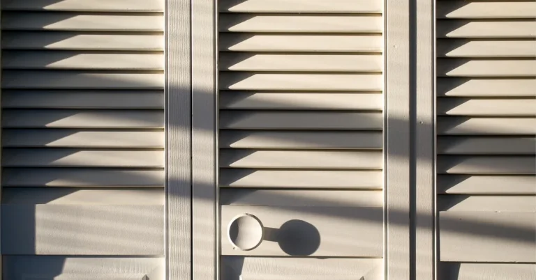 louvered bifold closet doors with pull holes, afternoon sunlight casting shadow lines