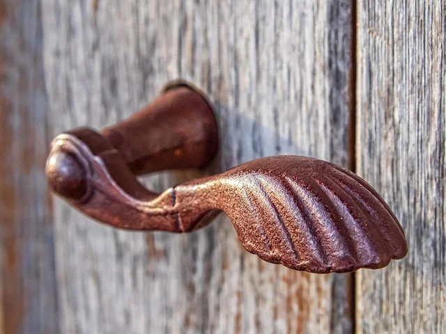 Old rusty door knob before removal