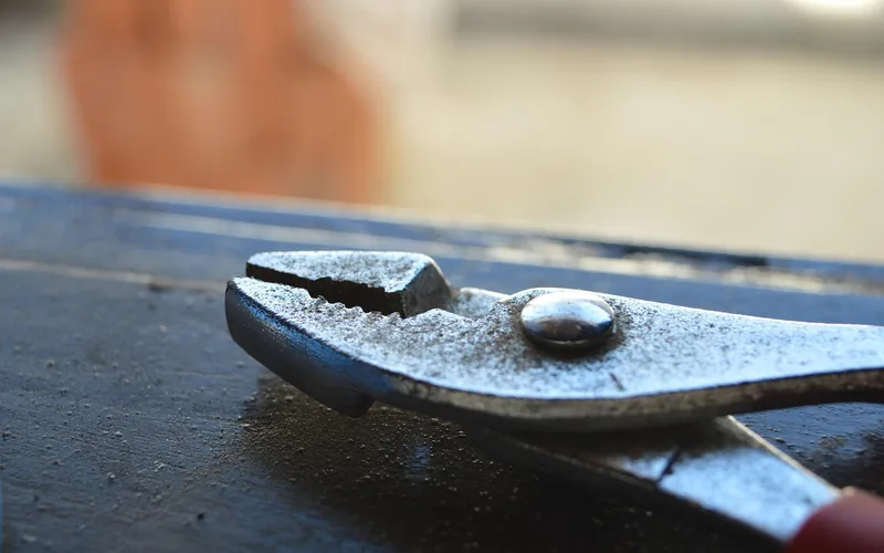close-up of pliers used for gripping shutter fastener pins
