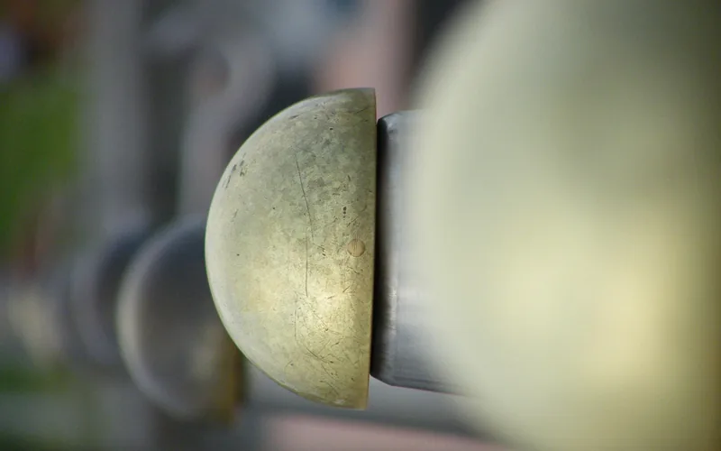 tarnished brass door hardware showing dark oxidized patina before cleaning