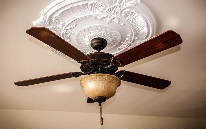 ceiling fan with a carved white medallion surrounding the mounting point ceiling fan with a carved white medallion surrounding the mounting point