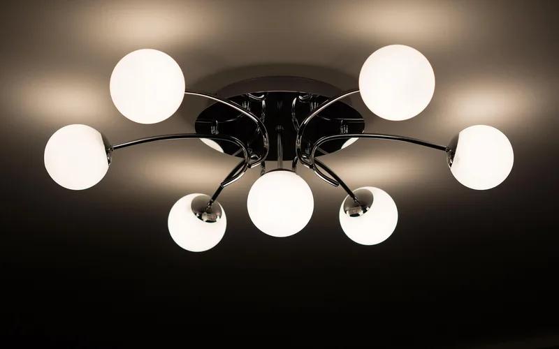 Ceiling lamp fixture with light bulb visible in a home interior Ceiling lamp fixture with light bulb visible in a home interior