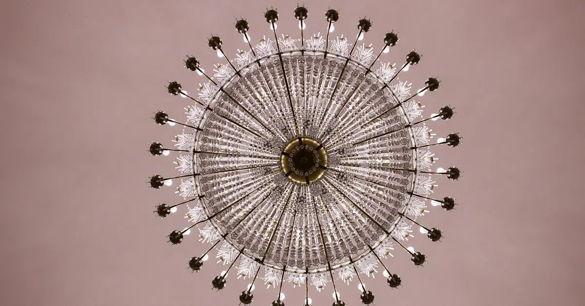 crystal chandelier hanging from a ceiling, viewed from below