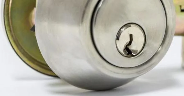 Deadbolt lock cylinder with keyhole and strike plate on a door
