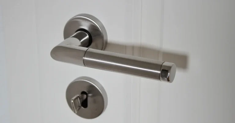 brushed nickel door lever handle mounted on a white interior door