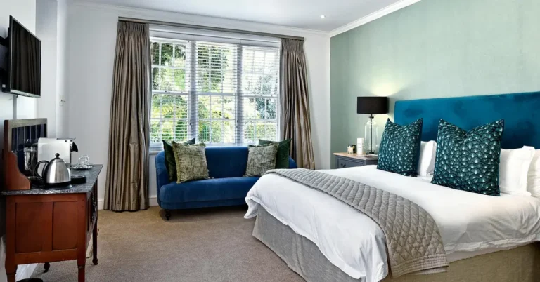White ceiling fan with light installed in a modern bedroom