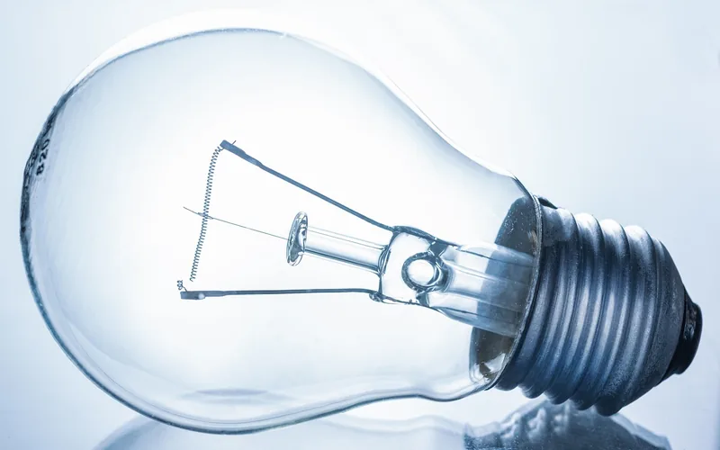 Incandescent light bulb glowing with visible filament