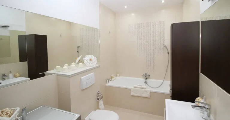 modern bathroom with a wall-hung toilet, bathtub, and vanity sink
