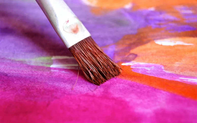 paintbrush applying color to fabric, similar to touching up a faded lamp shade paintbrush applying color to fabric, similar to touching up a faded lamp shade