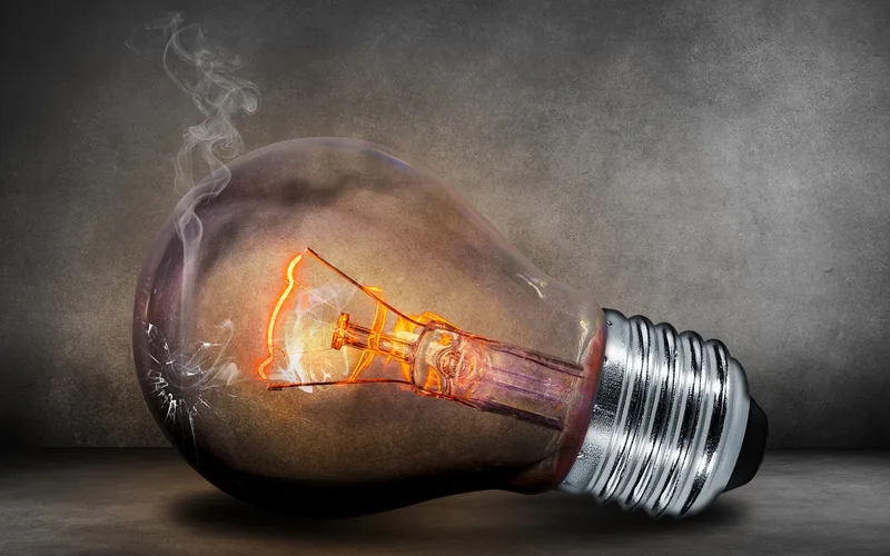 Close-up of a light bulb filament and glass housing