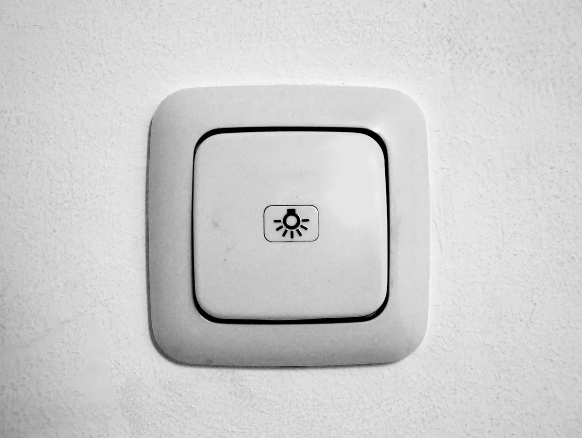 White light switch mounted on a home interior wall