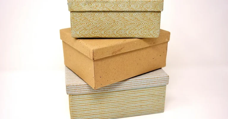 stack of sealed cardboard shipping boxes ready to mail at the post office