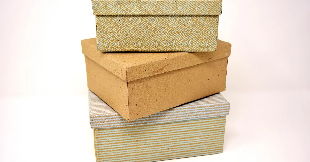 stack of sealed cardboard shipping boxes ready to mail at the post office