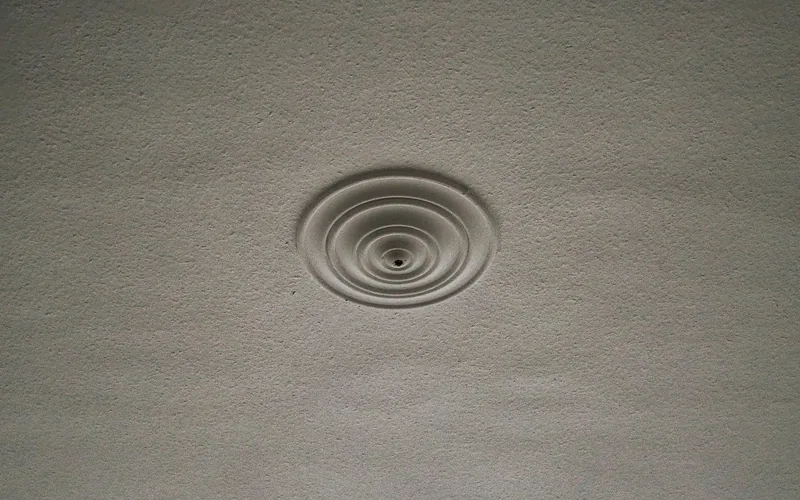 round plaster ceiling medallion installed before a light fixture is attached round plaster ceiling medallion installed before a light fixture is attached