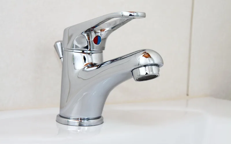 Close-up of a freshly cleaned brushed nickel faucet with a streak-free shine Close-up of a freshly cleaned brushed nickel faucet with a streak-free shine