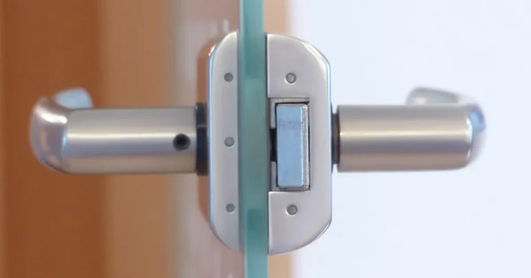 cutaway view of a door latch bolt mechanism inside a glass door, showing the angled bolt a card trick pushes back