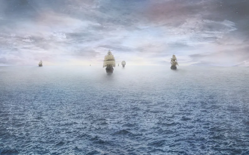 tall ships sailing across a misty ocean between continents tall ships sailing across a misty ocean between continents